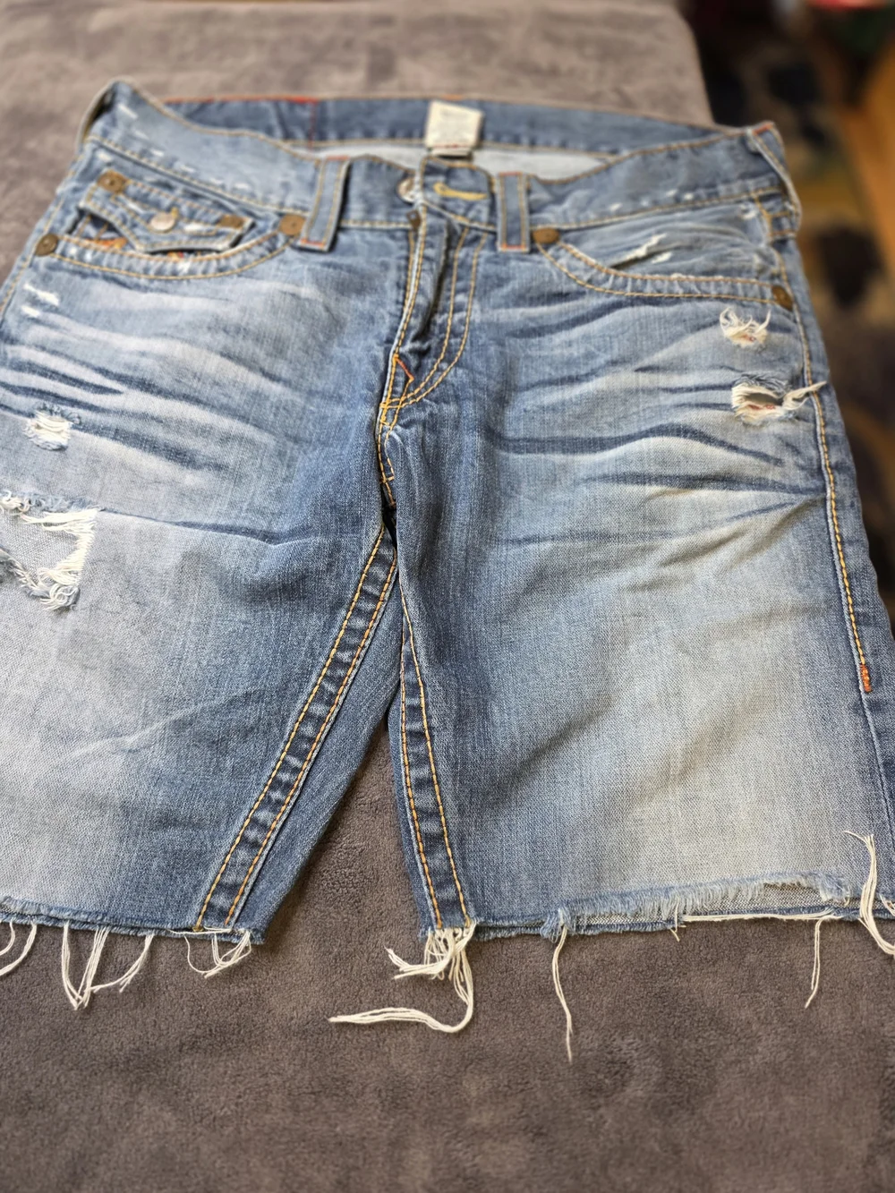 TRUE RELIGION Light Wash Cutoff Denim Shorts with Embroidered Back Pockets